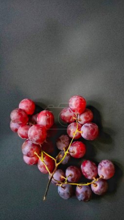 Photo for Top view a bunch of vitis vinifera fruits isolated on a black background - Royalty Free Image