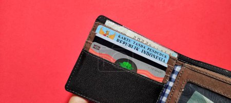 Photo for Several important identity cards in a wallet isolated on a red background. - Royalty Free Image