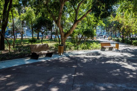 View of two empty benches at Georgiadi's park in the center of Heraklion city on a sunny day of October.