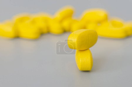 Several oval yellow pills, close-up, on a blue background. Blurred background