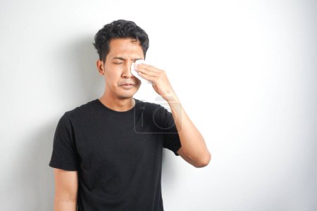 Photo for Man crying and wiping his tears with tissue - Royalty Free Image