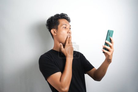 Photo for Wow face of man surprised while look at the smartphone - Royalty Free Image
