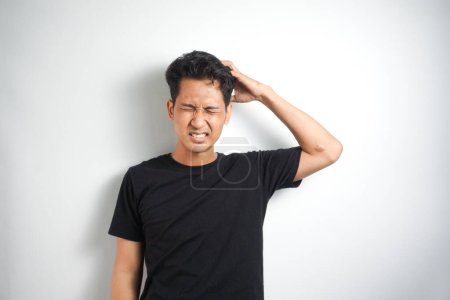 Photo for Portrait of man with hands on his head in front of white background. - Royalty Free Image