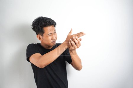 Photo for Strange asian man makes a gesture with hands like it a gun. White background. - Royalty Free Image