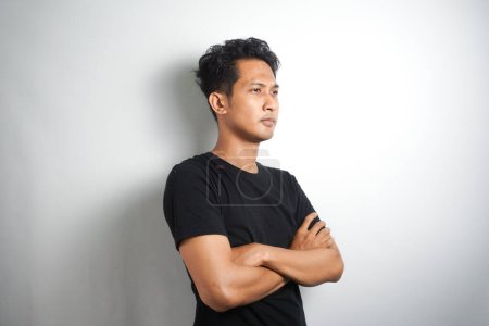 Photo for Happy young man. Portrait of handsome young man in black t shirt keeping arms crossed and smiling while standing against white background - Royalty Free Image