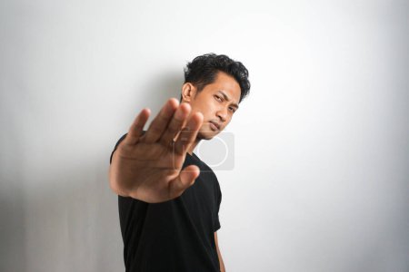 Photo for Asian handsome man over isolated background making stop gesture - Royalty Free Image