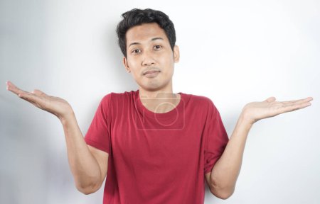Photo for Young hispanic man wearing casual clothes clueless and confused expression with arms and hands raised. doubt concept. - Royalty Free Image
