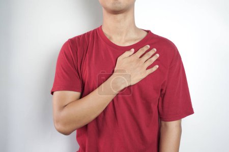 Photo for Body problem concept. Cropped close up photo portrait of unhappy sad upset guy holding touching left side of chest with hands in red t-shirt jeans isolated gray background - Royalty Free Image