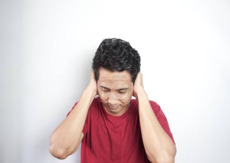 Photo for Unhappy man closing his ears by hands - Royalty Free Image