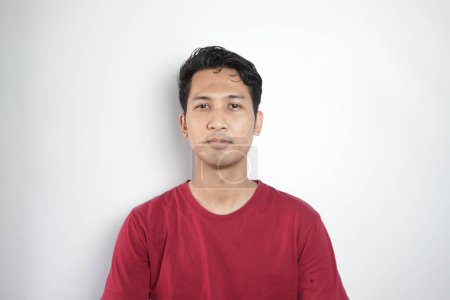 Photo for Young asian Indonesia man wearing t-shirt standing over isolated white background Relaxed with serious expression on face. Simple and natural looking at the camera. - Royalty Free Image