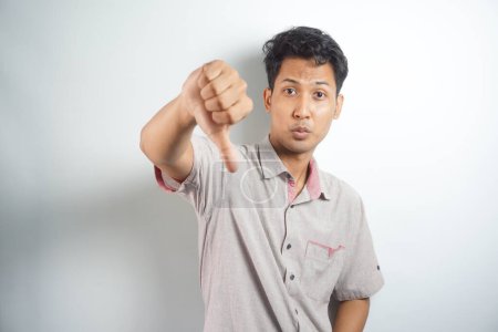 Photo for Angry annoyed, grumpy man giving thumbs down gesture - Royalty Free Image