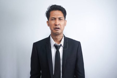Photo for Close-up of miserable man in suit, crying and sobbing, feeling sad, standing against white background - Royalty Free Image