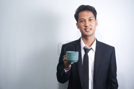 Photo for Young Business Man Drinking a Cup of Coffee or Tea - Royalty Free Image