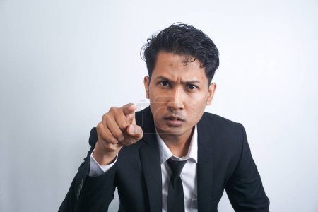 Photo for Furious young man pointing forefinger to camera blaming someone as guilty, or scolding isolated on white background. Angry guy screaming and showing with index being annoyed. - Royalty Free Image