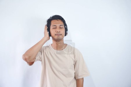 Photo for Peaceful positive modern man have black wireless headset listen music enjoy song melody close eyes feel pleasure wear casual style clothes isolated over white color background - Royalty Free Image