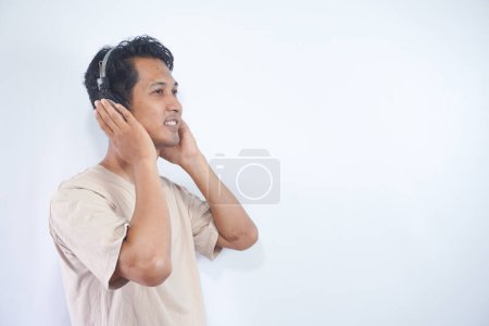 Photo for Peaceful positive modern man have black wireless headset listen music enjoy song melody close eyes feel pleasure wear casual style clothes isolated over white color background - Royalty Free Image