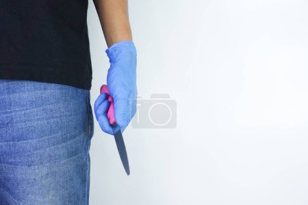Photo for Man's hand holds a knife with copy space on white background. topics of violence and murder. thief, killer, rapist, maniac - Royalty Free Image