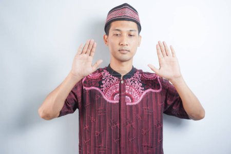 Photo for Asian muslim man doing the "Takbirotul Ihram" , a movement to start prayer - Royalty Free Image