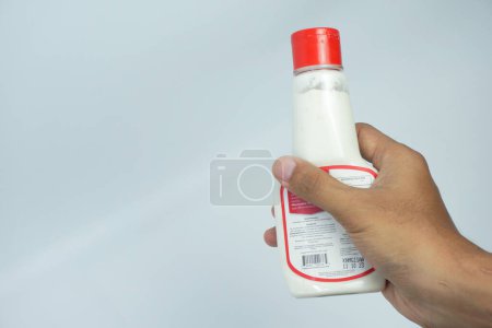 Photo for Close Up view of young man holding mayonnaise bottle on white background. - Royalty Free Image