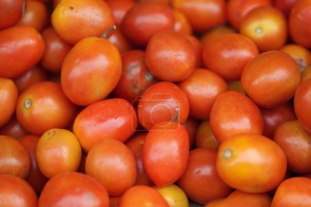 Photo for Tomatoes lying on a pile on top of each other, tomato texture. Selective focus. - Royalty Free Image