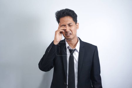 Photo for Funny asian man wearing suit crying wipes tears losing his job. - Royalty Free Image