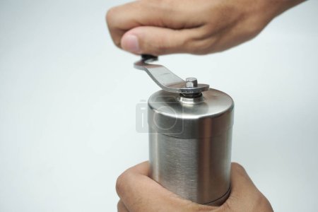 Photo for Hands holding manual grinder with coffee beans. - Royalty Free Image