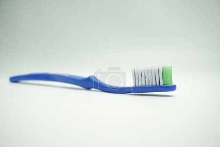 Photo for Blue plastic toothbrush, the top view, sideways and in the long term, on a white background - Royalty Free Image