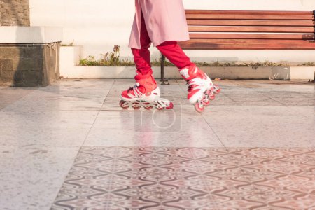Photo for Girl in the park playing roller skates - Royalty Free Image