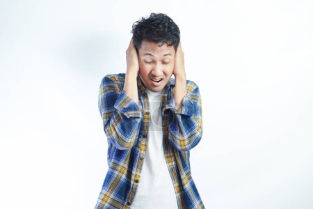 Adulte asiatique homme criant désespéré tandis que fermer ses oreilles avec la main