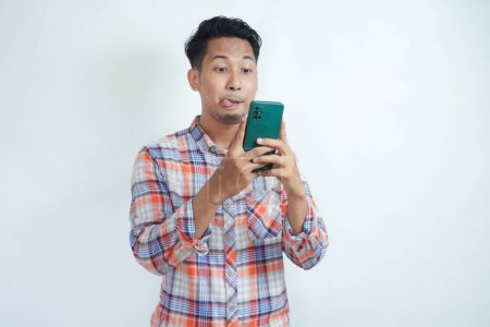 Photo for Adult Asian man waste his money for online shopping using mobile phone - Royalty Free Image