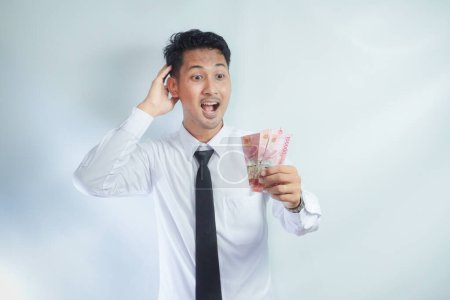 Adulto asiático hombre mostrando feliz cara expresión mientras celebración de papel moneda