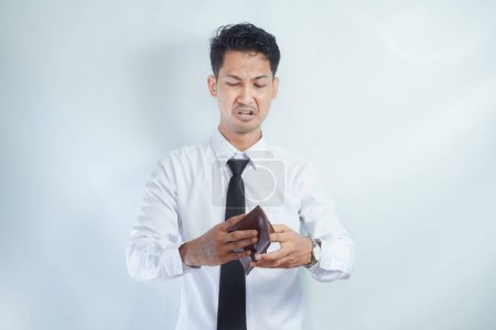 Adult Asian man showing shocked expression when looking to his empty wallet