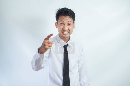 Photo for Adult Asian man looking to camera with angry expression while pointing finger forward - Royalty Free Image