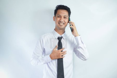 Photo for Adult Asian man smiling happy when calling with someone - Royalty Free Image