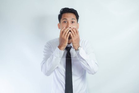 Photo for Headshot of terrified fearful young Asian businessman covering mouth and looking at camera with scared expression on his face, afraid of being fired failure at work - Royalty Free Image