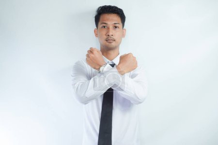 Adult Asian man making cross sign with his hand with serious expression
