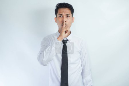 Office worker showing keep silent gesture