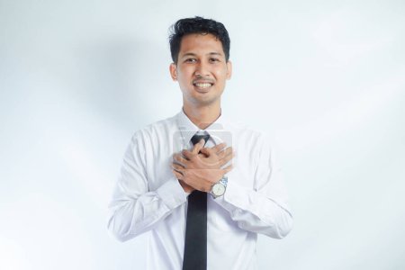 Jeune homme d'affaires asiatique portant une chemise blanche montrant geste soulagé