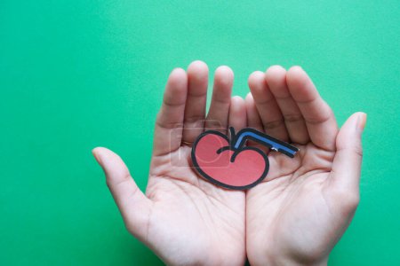 Photo for Hands holding kidney shaped paper, world kidney day, National Organ Donor Day, charity donation concept - Royalty Free Image