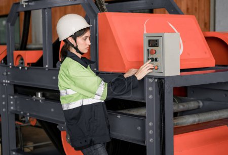 Photo for Experienced sheet metal workers use a computerized metalworking control panel display to create and regulate heavy gear. Automating and streamlining the placement of roofing modules for installation. - Royalty Free Image