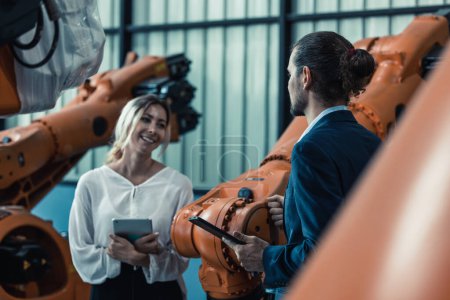 Photo for Robotic factory owner explain, discuss functionality and performance of robot systems with client. Answering questions about after-sales service. Price negotiation. Developing long-term relationships - Royalty Free Image