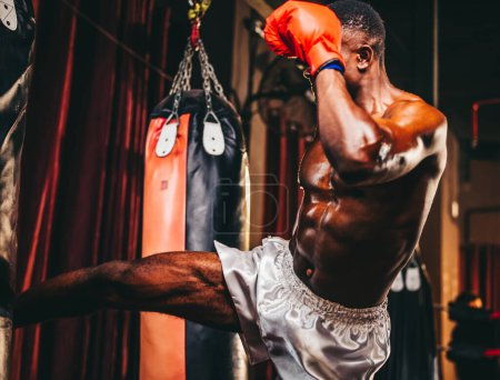 Photo for Boxers at the professional level routinely train by punching and kicking sandbags. To be successful in the individual's career, self-discipline, determination, and patience are essential qualities. - Royalty Free Image