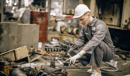 Photo for Engineering technicians use hand tools to perform regular maintenance by inspecting, testing, repairing machinery and engines to ensure they stay in standard condition. Identifying any malfunctions. - Royalty Free Image
