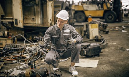 Photo for Engineering technicians use hand tools to perform regular maintenance by inspecting, testing, repairing machinery and engines to ensure they stay in standard condition. Identifying any malfunctions. - Royalty Free Image