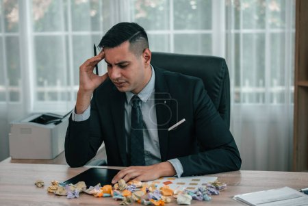 Photo for After having difficulties with project's actual implementation, designers feel stress and concern, which causes them to angrily crumple some sticky notes, that contained a number of different ideas. - Royalty Free Image
