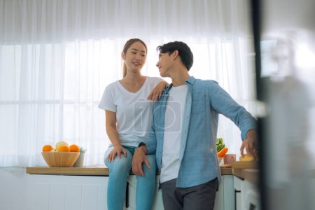 Photo for Married couples spend a few tender minutes before staring their workday. Sharing, laughing, teasing, serving each other loaf and beverage, Mutual understanding, sympathy and a supportive life partner - Royalty Free Image