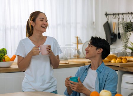 Photo for Married couples spend a few tender minutes before staring their workday. Sharing, laughing, teasing, serving each other loaf and beverage, Mutual understanding, sympathy and a supportive life partner - Royalty Free Image