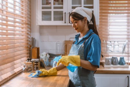 Photo for Enthusiastic house cleaning lady do various tasks with responsibility. Using mop, broom, laundry machine, cleaning supplies to wipe, scrub, and dust furniture, glassware, floors, clothes, dishes. - Royalty Free Image