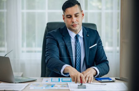 Photo for The determined business supervisor carefully analyzes the proposal contract before permitting. Once approved, the project is implemented with serious consideration, ensuring successful outcomes. - Royalty Free Image
