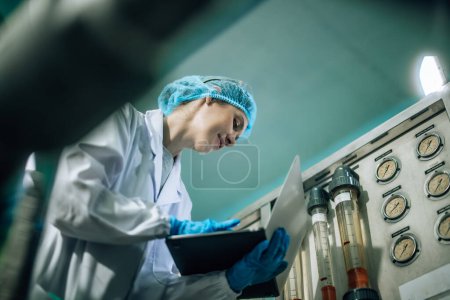 Photo for Drinking Water Quality Officer performs effective assessment, monitoring reverse osmosis systems to maintain high standards, efficiency, safety, while controlling contamination through expert testing - Royalty Free Image